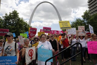 FILE - Abortion-rights supporters take part in a protest Thursday, May 30, 2019, in St. Louis. Some Republican state lawmakers have proposed a measure that would allow women who have abortions to be charged with homicide. (AP Photo/Jeff Roberson, File)