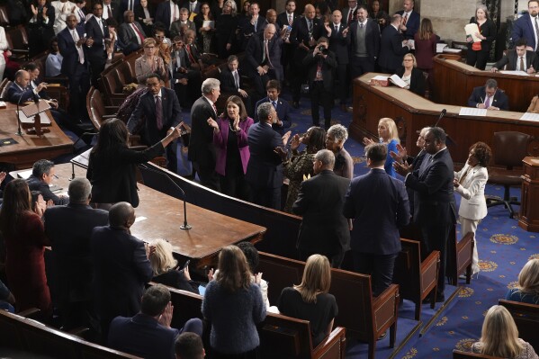 Democrats applaud as non-voting Del. Stacey Plaskett, D-Virgin Islands, protests as the House of Representatives meets to elect a speaker and convene the new 119th Congress at the Capitol in Washington, Friday, Jan. 3, 2025. (AP Photo/Jacquelyn Martin)