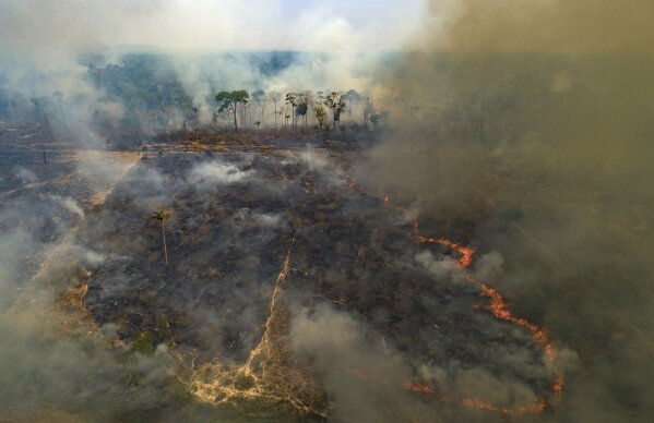FILE - In this Aug. 23, 2020, file photo, fire consumes land recently deforested by cattle farmers near Novo Progresso, Para state, Brazil. Climate-connected disasters seem everywhere in the crazy year 2020. But scientists Wednesday, Sept. 9, say it'll get worse. (AP Photo/Andre Penner, File)