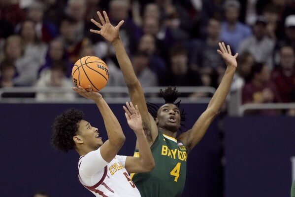 Iowa State guard Curtis Jones (5) shoots under pressure from Baylor guard Ja'Kobe Walter (4) during the first half of an NCAA college basketball game in the semifinal round of the Big 12 Conference tournament, Friday, March 15, 2024, in Kansas City, Mo. Houston won 82-59. (AP Photo/Charlie Riedel)