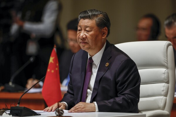 FILE - China's President Xi Jinping attends the plenary session during the 2023 BRICS Summit in Johannesburg, South Africa, on Aug. 23, 2023. China and Syria will announce the formation of a strategic partnership, Chinese leader Xi Jinping said Friday, Sept. 22, 2023, at the start of a meeting with Syrian President Bashar Assad in southern China. (Gianluigi Guercia/Pool via AP, File)