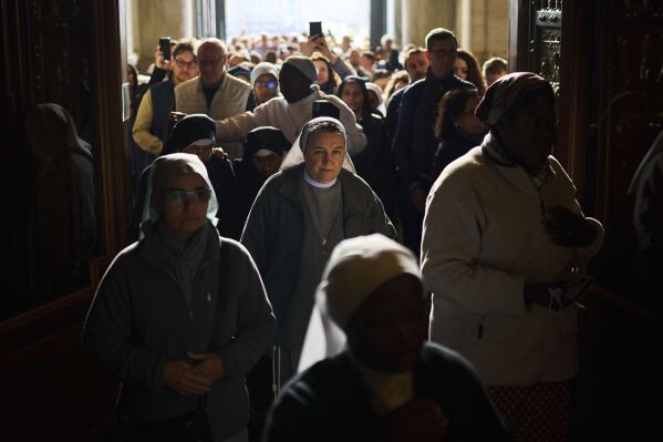 People line up as they enter St. Peter's Basilica to pay their respects to Pope Francis lying in state, at the Vatican, Thursday, April 24, 2025. (AP Photo/Emilio Morenatti)