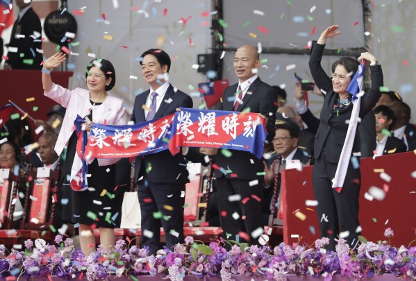 From left, Taiwan first lady Wu Mei-ru, Taiwanese President Lai Ching-te, Speaker of the Legislature Han Guo-yu and Vice President Hsiao Bi-khim cheer during National Day celebrations in front of the Presidential Building in Taipei, Taiwan, Thursday, Oct. 10, 2024. (AP Photo/Chiang Ying-ying)
