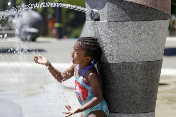 Mellena O'Brien, 4, plays in the Yesler TerraceSpray Park during a heat wave hitting the Pacific Northwest, Sunday, June 27, 2021, in Seattle. Yesterday set a record high for the day with more record highs expected today and Monday. (AP Photo/John Froschauer)
