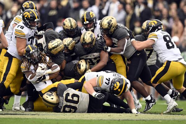 Iowa running back Jaziun Patterson,left, carries the ball during the second half of an NCAA college football game against Purdue, Saturday, Nov. 5, 2022, in West Lafayette, Ind. (AP Photo/Marc Lebryk)
