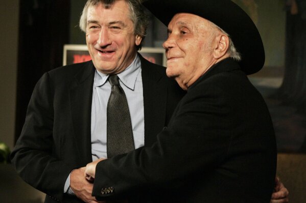 FILE - In this Jan. 27, 2005, file photo, Robert De Niro, left, and boxer Jake LaMotta stand for photographers before watching a 25th anniversary screening of the movie "Raging Bull," in New York. The Associated Press has compiled a list of the best sports movies ever made — a one-of-a-kind AP Top 25. Seventy writers and editors who work for the company around the world participated in the vote.  (AP Photo/Julie Jacobson, File)