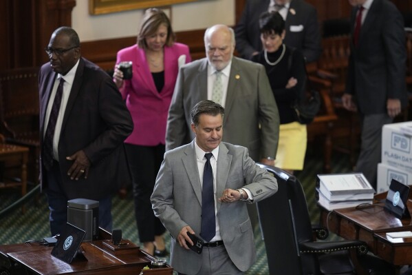 Texas state Sen. Roland Gutierrez, front center, and other state senators acting as jurors enter the Senate Chamber for day six of the impeachment trial for Texas Attorney General Ken Paxton at the Texas Capitol, Wednesday, Sept. 13, 2023, in Austin, Texas. (AP Photo/Eric Gay)