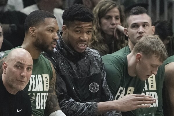Milwaukee Bucks' Giannis Antetokounmpo talks to Damian Lillard on the bench during the first half of Game 2 of the NBA playoff basketball game Tuesday, April 23, 2024, in Milwaukee. (AP Photo/Morry Gash)