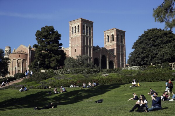 FILE - Students sit on the lawn near Royce Hall at the University of California, Los Angeles, in the Westwood section of Los Angeles on April 25, 2019. On Thursday, March 21, 2024, the California Legislature voted to extend the deadline for some state student financial aid programs in response to delays with the Free Application for Federal Student Aid, or FAFSA. (AP Photo/Jae C. Hong, File)