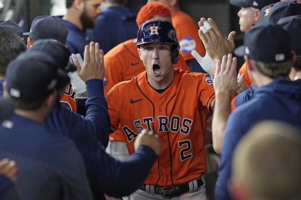 FILE - Houston Astros' Alex Bregman (2) celebrates in the dugout after hitting a home run against the Texas Rangers during the first inning in Game 5 of the baseball American League Championship Series Friday, Oct. 20, 2023, in Arlington, Texas. Astros general manager Dana Brown says the team isn't exploring trades for Alex Bregman, even though the All-Star third baseman’s contract is set to expire after the 2024 season. (APPhoto/Godofredo A. Vásquez, File)