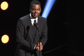 FILE - In this March 30, 2019 file photo, Chris Rock presents the award for outstanding comedy series at the 50th annual NAACP Image Awards at the Dolby Theatre in Los Angeles. Chris Rock on Sunday, Sept. 19, 2021 said he has been diagnosed with COVID-19 and sent a message to anyone still on the fence: “Get vaccinated.”  (Photo by Chris Pizzello/Invision/AP, File)