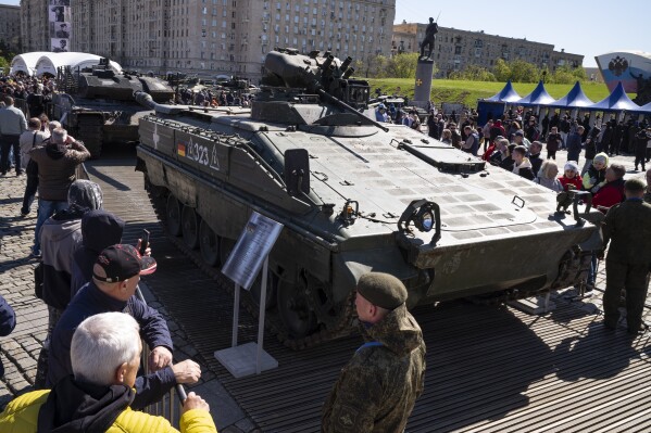 Visitors look at a Marder armored infantry vehicle from Germany at an exhibition of Western military equipment captured from Kyiv forces during the fighting in Ukraine, in Moscow on Friday, May 3, 2024. The exhibit organized by the Russian Defense Ministry features more than 30 pieces of Western-made heavy equipment, including a U.S.-made M1 Abrams tank and a Bradley armored fighting vehicle. (Ǻ Photo/Alexander Zemlianichenko)