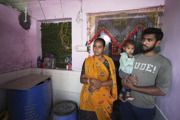 Akashbhai Thakor, right, and his wife Kumud stand at their house in Ahmedabad, India, Thursday, April 3, 2025. (AP Photo/Ajit Solanki)