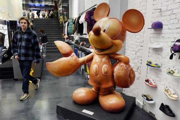 "Lobsta Mickey" is displayed in the Concepts sneaker store, Friday, Nov. 25, 2022, in Boston. The 700-pound, long-forgotten statue of Mickey Mouse with giant lobster claws for hands has found its way back to Boston. (AP Photo/Michael Dwyer)