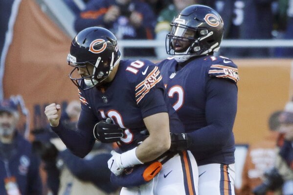 
              Chicago Bears quarterback Mitchell Trubisky (10) celebrates a touchdown with offensive tackle Charles Leno (72) during the second half of an NFL football game against the Green Bay Packers Sunday, Dec. 16, 2018, in Chicago. (AP Photo/David Banks)
            