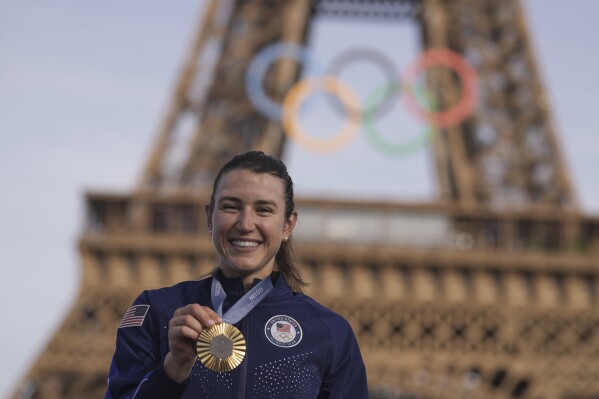 Kristen Faulkner, of the United States, poses with the gold medal of the women's road cycling event, at the 2024 Summer Olympics, Sunday, Aug. 4, 2024, in Paris, France. (AP Photo/Thibault Camus)