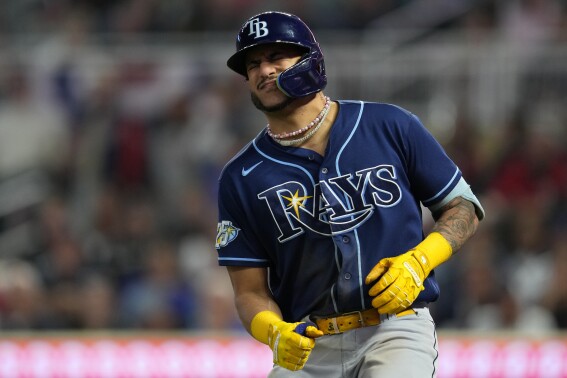 Tampa Bay Rays' Jose Siri reacts after being hit by a pitch during the fifth inning of a baseball game against the Minnesota Twins, Monday, Sept. 11, 2023, in Minneapolis. (AP Photo/Abbie Parr)