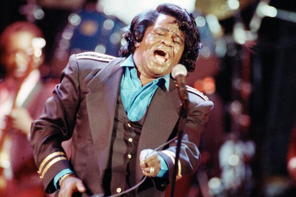 FILE - Gospel-soul singer James Brown sings "Living in America" during a concert in Los Angeles on June 10, 1991. Mick Jagger and Ahmir "Questlove" Thompson are teaming up to help produce a four-part documentary series on soul legend James Brown. The series is expected to appear on the A&E Network in 2023, around the 90th anniversary of Brown's birth. (AP Photo/Kevork Djansezian, File)