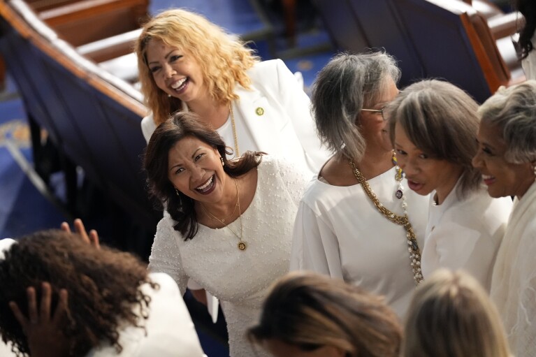 Rep. Norma Torres, D-Calif., center, and Rep. Lucy McBath, D-Ga., back center, wear white to support reproductive rights, as President Joe Biden prepares to deliver the State of the Union address to a joint session of Congress at the U.S. Capitol, Thursday March 7, 2024, in Washington. (AP Photo/Andrew Harnik)