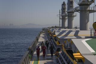 FILE - Crew members of the cargo ship Med Island, which came from Ukraine loaded with grain, prepare the ship for inspection by U.N. officials, while it is anchored in the Marmara Sea in Istanbul, Turkey, Saturday, Oct. 1, 2022. Kyiv is seeking to extend the unprecedented wartime deal that allows grain to flow from Ukraine to countries in Africa, the Middle East and Asia where hunger is a growing threat, a top Ukrainian official said Thursday, May 11, 2023 after the talks on prolonging the agreement concluded in Turkey. (AP Photo/Khalil Hamra, File)