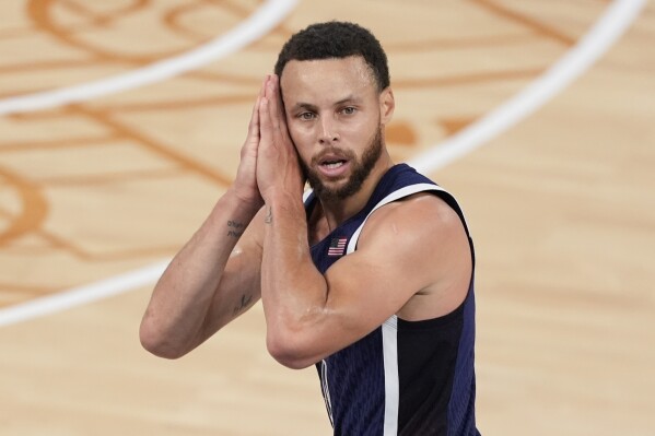 United States' Stephen Curry (4) reacts after a three-point basket against France in the men's gold medal basketball game at the 2024 Summer Olympics, Saturday, Aug. 10, 2024 in Paris, France. (AP Photo/Michael Conroy, File)