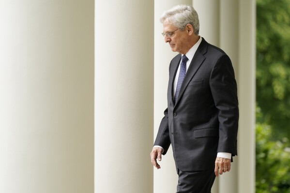 FILE - Attorney General Merrick Garland arrives with President Joe Biden for an event in the Rose Garden of the White House in Washington, May 13, 2022. The Justice Department is facing the biggest test in its history in the prosecution of former President Donald Trump. Try as Garland might, though, there is no escaping the politics of the moment when the Justice Department of a president who is running for reelection is indicting his chief political rival, the front-runner for the Republican nomination. (AP Photo/Andrew Harnik, File)