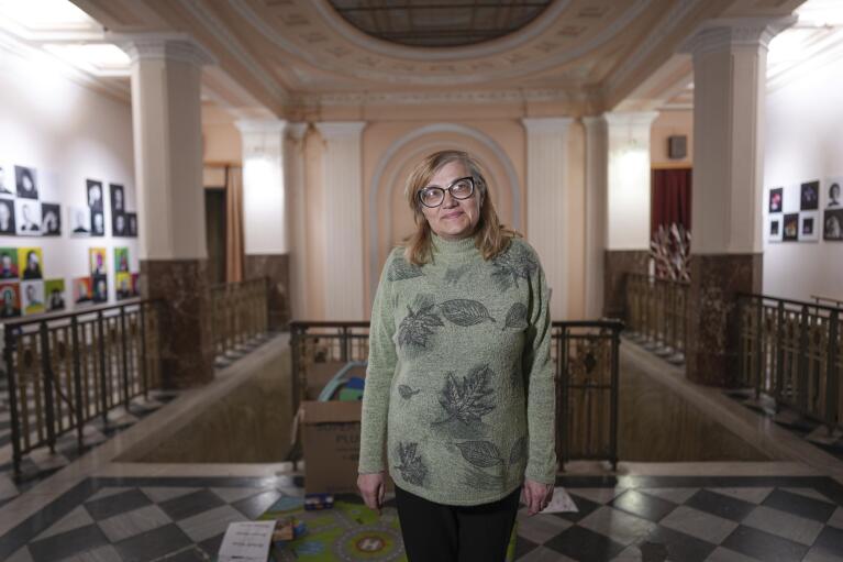 Galina Kutnyakova, teacher and survivor of the bombing at the Donetsk Academic Regional Drama Theatre in Mariupol, Ukraine, poses for a photo at the Lviv Regional Academic Puppet Theater in Lviv, Ukraine, on April 2, 2022. The March 16, 2022, bombing stands out as the single deadliest known attack against civilians to date in the war in Ukraine. (AP Photo/Evgeniy Maloletka)