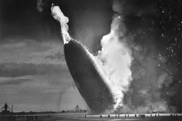 FILE - In this May 6, 1937 file photo, the German dirigible Hindenburg crashes to earth in flames after exploding at the U.S. Naval Station in Lakehurst, N.J. (AP Photo/Murray Becker, File)