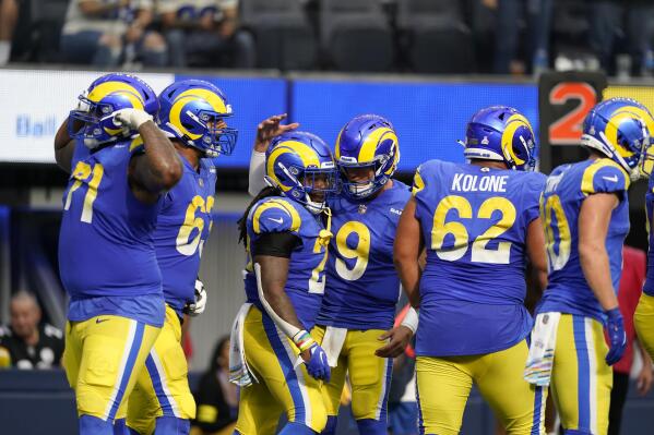 Los Angeles Rams running back Darrell Henderson Jr., center left, celebrates his rushing touchdown with quarterback Matthew Stafford (9) during the second half of an NFL football game against the Carolina Panthers Sunday, Oct. 16, 2022, in Inglewood, Calif. (AP Photo/Ashley Landis)
