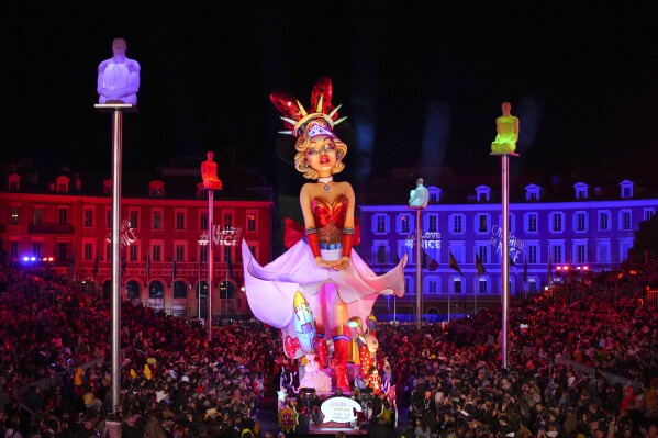 A carnival float depicting a queen parades through Place Massena during the opening ceremony of 151st edition of the Nice Carnival in Nice, southern France, Saturday, Feb. 17, 2024. (AP Photo/Daniel Cole)