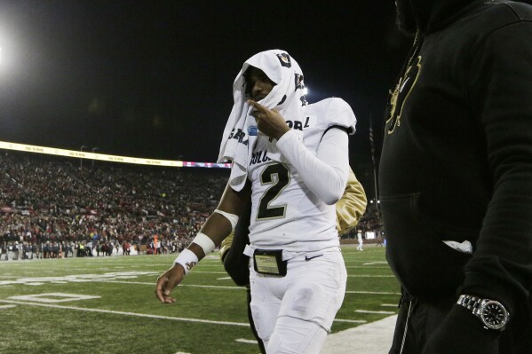 Colorado quarterback Shedeur Sanders (2) walks toward the locker room during the first half of the team's NCAA college football game against Washington State, Friday, Nov. 17, 2023, in Pullman, Wash. (AP Photo/Young Kwak)