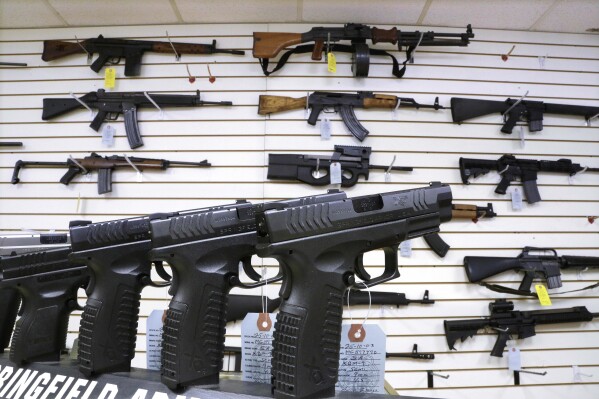 FILE - Assault weapons and hand guns are seen for sale at Capitol City Arms Supply on Jan. 16, 2013, in Springfield, Ill. Republican support for gun restrictions is slipping a year after Congress passed the most comprehensive firearms control legislation in decades with bipartisan support, according to a poll from The Associated Press-NORC Center for Public Affairs Research. (AP Photo/Seth Perlman, File)
