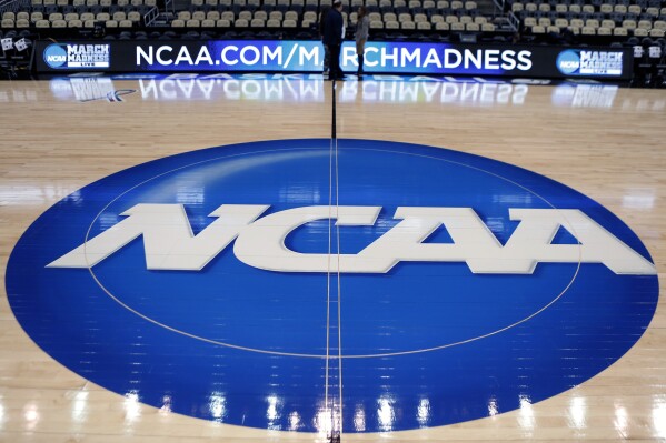 FILE - In this March 18, 2015, file photo, the NCAA logo is displayed at center court at The Consol Energy Center in Pittsburgh. More than half of Americans say they are against college athletes unionizing, though younger respondents were more supportive than older, according to a new poll from The Associated Press-NORC Center for Public Affairs Research. (AP Photo/Keith Srakocic, File)