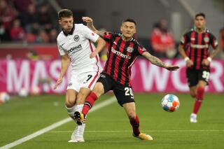 Frankfurt's Ajdin Hrustic, left, and Leverkusen's Charles Aranguiz challenge for the ball during the German Bundesliga soccer match between Bayer Leverkusen and Eintracht Frankfurt in Leverkusen, Germany, Monday, May 2, 2022. (AP Photo/Martin Meissner)