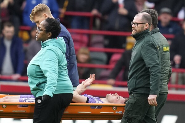 Liverpool's Diogo Jota is carried off the pitch on a stretcher after getting injured during the English Premier League soccer match between Brentford and Liverpool at the Gtech Community Stadium in London, Saturday, Feb. 17, 2024. (AP Photo/Kirsty Wigglesworth)