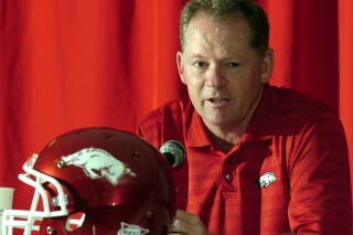 FILE - Arkansas football coach Bobby Petrino answers a question during media day at the Broyles Center in Fayetteville, Ark., Tuesday, Aug. 5, 2008. Arkansas announced Wednesday, Nov. 29, 2023, it is bringing back Bobby Petrino to be offensive coordinator, 11 years after he was fired as head coach in a sordid scandal that involved a motorcycle accident, an affair with a woman who worked for him and being untruthful to his bosses.(AP Photo/April L. Brown, File)