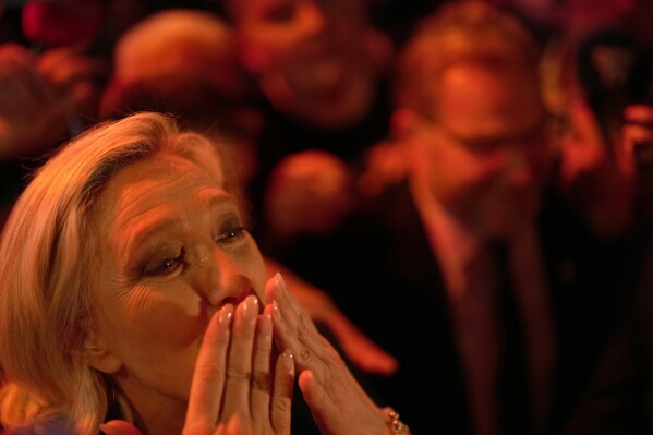 French far right leader Marine Le Pen blows a kiss after delivering her speech after the release of projections based on the actual vote count in select constituencies in Henin-Beaumont, northern France, Sunday, June 30, 2024. (AP Photo/Thibault Camus)