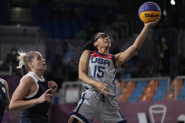 FILE - United States' Allisha Gray (15) heads to the basket past Evgeniia Frolkina (16), of the Russian Olympic Committee, during a women's 3-on-3 gold medal basketball game at the 2020 Summer Olympics, July 28, 2021, in Tokyo, Japan. Gray is glad to be back playing 3x3 with an eye toward being a member of the team at the Paris Olympics this summer. She is the only player returning from the foursome that took home the gold at the Tokyo Games three years ago. (Ǻ Photo/Jeff Roberson, File)