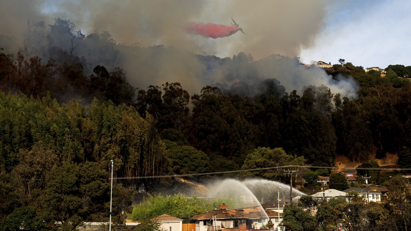 A fast-spreading wildfire in California burned two homes while others were damaged by smoke and water