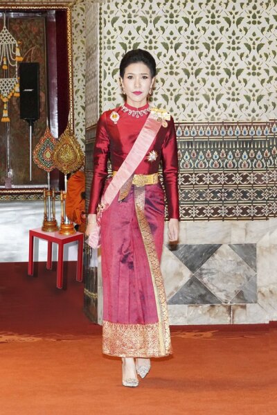 This undated photo posted Monday, Aug. 26, 2019, on the Thailand Royal Office website, shows Major General Sineenatra Wongvajirabhakdi, the royal noble consort of Thailand's King Maha Vajiralongkorn, posing in a royal dress. Late Monday, Oct. 21, 2019, it was announced that Thailand's king has stripped Sineenatra of her titles and military ranks for disloyalty, accusing her of seeking to undermine the position of his official wife for her own benefit. (Thailand Royal Office via AP)