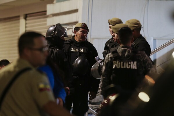 Police guard the hospital where several of the injured were taken after an attack against presidential candidate Fernando Villavicencio in Quito, Ecuador, Wednesday, Aug. 9, 2023. Villavicencio was killed outside a school as he entered a vehicle after a campaign rally. (AP Photo/Juan Diego Montenegro)