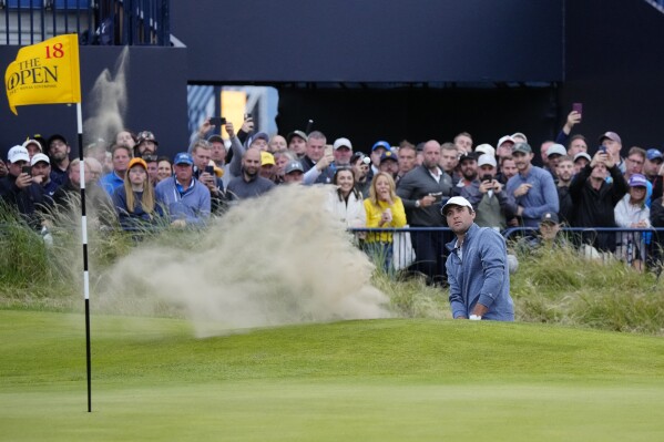 United States' Scottie Scheffler plays out of a bunker on the 18th green during the second day of the British Open Golf Championships at the Royal Liverpool Golf Club in Hoylake, England, Friday, July 21, 2023. (AP Photo/Jon Super)