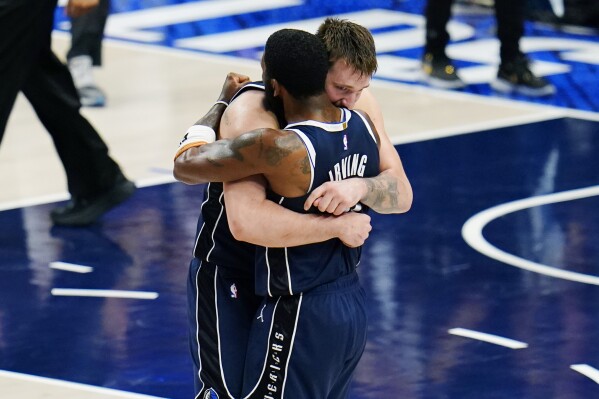 Dallas Mavericks guard Luka Doncic, left, and guard Kyrie Irving, right, embrace after their win over theMinnesota Timberwolves in Game 3 of the NBA basketball Western Conference finals, Sunday, May 26, 2024, in Dallas. (AP Photo/Gareth Patterson)