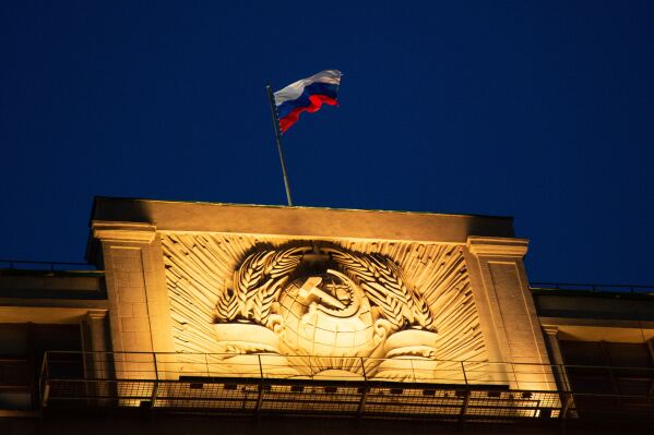 A Russian state flag waves on top of a hummer and sickle at the State Duma, lower parliament chamber, headquarters in Moscow, Russia, Sunday, March 3, 2019. (AP Photo/Alexander Zemlianichenko, File)
