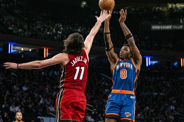 New York Knicks forward OG Anunoby (8) shoots over Miami Heat guard Jaime Jaquez Jr. (11) during the second half of an NBA basketball game, Saturday, Jan. 27, 2024, in New York. (AP Photo/Peter K. Afriyie)