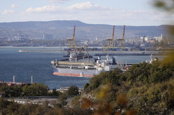 FILE - An oil tanker is moored at the Sheskharis complex, part of Chernomortransneft JSC, a subsidiary of Transneft PJSC, in Novorossiysk, Russia, on Oct. 11, 2022, one of the largest facilities for oil and petroleum products in southern Russia. Oil prices have risen, meaning drivers are paying more for gasoline and truckers and farmers more for diesel. The increase also is complicating the global fight against inflation and feeding Russia's war chest to boot. (AP Photo, File)