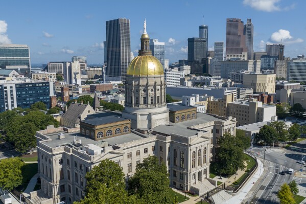 FILE - The gold dome of the Georgia Capitol gleams in the sun, Aug. 27, 2022, in front of the skyline of downtown Atlanta. Legislation that would ban some citizens of China from owning farmland in Georgia is advancing at the state Capitol despite criticism that it promotes xenophobia and could face legal hurdles. (AP Photo/Steve Helber, File)