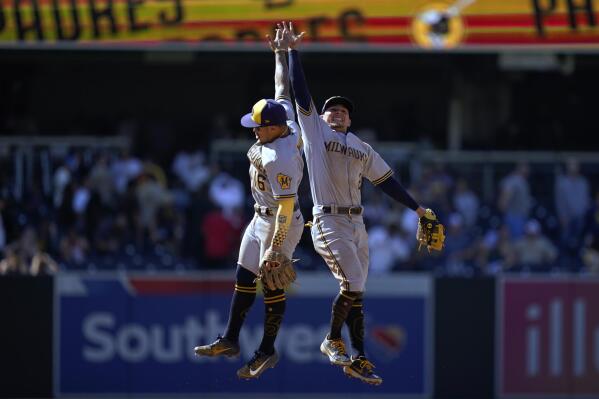 Milwaukee Brewers shortstop Luis Urias, right, celebrates with second baseman Kolten Wong after the Brewers defeated the San Diego Padres 2-1 in a baseball game Wednesday, May 25, 2022, in San Diego. (AP Photo/Gregory Bull)