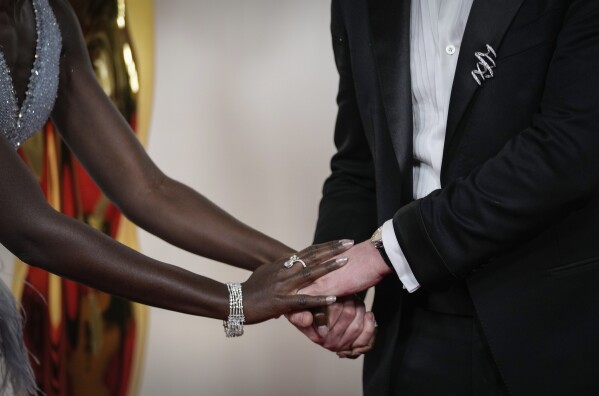 Lupita Nyong'o, left, and Joseph Quinn arrive at the Oscars on Sunday, March 10, 2024, at the Dolby Theatre in Los Angeles. (AP Photo/Ashley Landis)