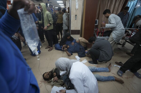 Palestinians wounded in the Israeli bombardment of the Gaza Strip are brought to Al Aqsa hospital in Deir al Balah, Gaza Strip, Sunday, Jan. 7, 2024. (AP Photo/Adel Hana)